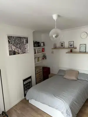 Un ou plusieurs lits dans un hébergement de l'établissement Cozy Appartment in Voltaire