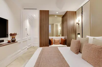 Un ou plusieurs lits dans un hébergement de l'établissement TheLander - Serviced Apartments in Saint Germain des Prés