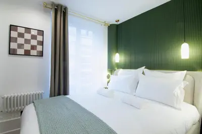 Un ou plusieurs lits dans un hébergement de l'établissement Appartement élégant près de Bastille-Gare de Lyon