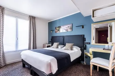 Un ou plusieurs lits dans un hébergement de l'établissement hotel Louvre Sainte Anne