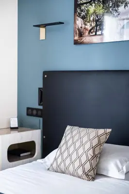 Un ou plusieurs lits dans un hébergement de l'établissement hotel Louvre Sainte Anne
