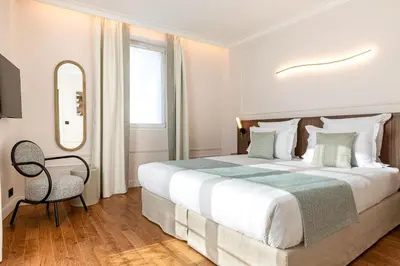 Un ou plusieurs lits dans un hébergement de l'établissement Villa SoPi Appart'Hotel by Patrick Hayat