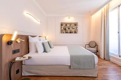 Un ou plusieurs lits dans un hébergement de l'établissement Villa SoPi Appart'Hotel by Patrick Hayat