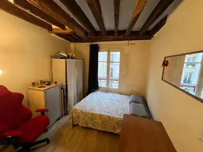 Un ou plusieurs lits dans un hébergement de l'établissement Cozy studio Bastille