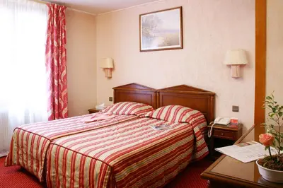 Un ou plusieurs lits dans un hébergement de l'établissement Hotel Meslay Republique