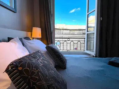 Un ou plusieurs lits dans un hébergement de l'établissement L'appartement des Archives