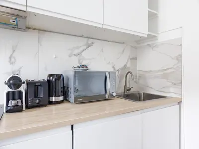 Cuisine ou kitchenette dans l'établissement Cosy Studio Etoile Friedland