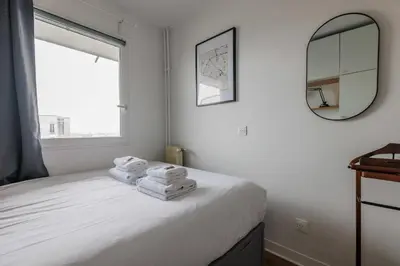 Un ou plusieurs lits dans un hébergement de l'établissement Charming apartment with balcony and view - 1BDR 2P - 19th arr