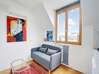 Coin salon dans l'établissement Cosy appt 1BDR 2P - Arc de Triomphe
