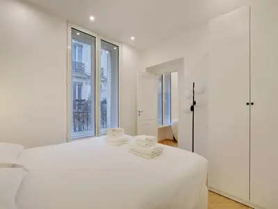 Un ou plusieurs lits dans un hébergement de l'établissement Elegant apartment 3BDR 6P - Champs-Élysées