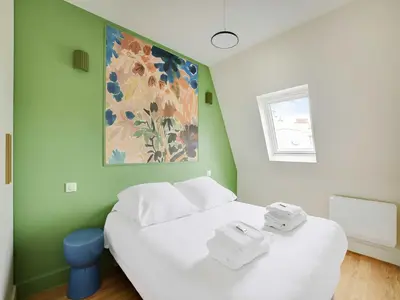 Un ou plusieurs lits dans un hébergement de l'établissement Bright apartment - 2BDR- 4P- Jardin du Luxembourg