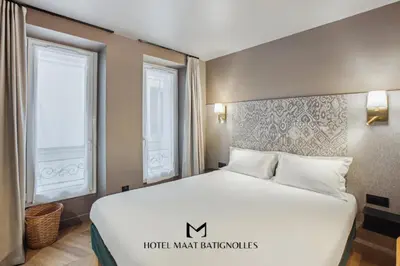 Un ou plusieurs lits dans un hébergement de l'établissement Hôtel Maât Batignolles