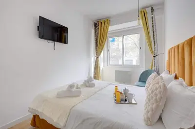 Un ou plusieurs lits dans un hébergement de l'établissement COSY Appartement Paris Centre
