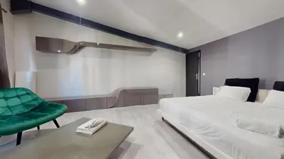 Un ou plusieurs lits dans un hébergement de l'établissement Loft cosy