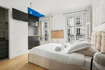 Un ou plusieurs lits dans un hébergement de l'établissement Studio Arc de Triomphe