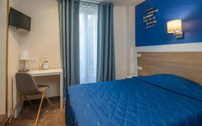 Un ou plusieurs lits dans un hébergement de l'établissement Hotel Terminus Montparnasse