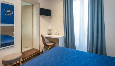 Un ou plusieurs lits dans un hébergement de l'établissement Hotel Terminus Montparnasse