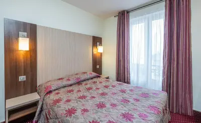 Un ou plusieurs lits dans un hébergement de l'établissement Hotel Terminus Montparnasse