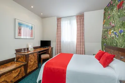 Un ou plusieurs lits dans un hébergement de l'établissement Hotel Terminus Montparnasse