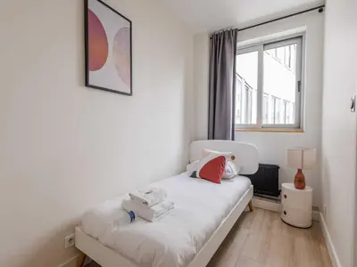 Un ou plusieurs lits dans un hébergement de l'établissement Appart proche Quai de Seine - 2BDR 3P 16ème Arr