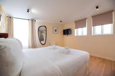 Un ou plusieurs lits dans un hébergement de l'établissement CIA - Home on Grands Boulevards