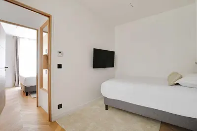 Un ou plusieurs lits dans un hébergement de l'établissement Appartement Moderne - 3BR-6P - Montorgueil