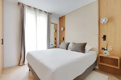 Un ou plusieurs lits dans un hébergement de l'établissement Appartement Moderne - 3BR-6P - Montorgueil