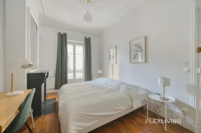 Un ou plusieurs lits dans un hébergement de l'établissement Cozy Room in Alésia Paris 14th