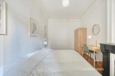 Un ou plusieurs lits dans un hébergement de l'établissement Cozy Room in Alésia Paris 14th