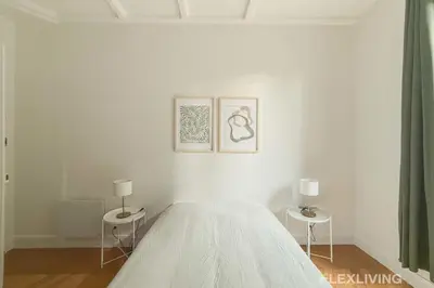 Un ou plusieurs lits dans un hébergement de l'établissement Cozy Room in Alésia Paris 14th