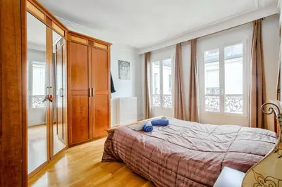Un ou plusieurs lits dans un hébergement de l'établissement Appartement au coeur du 17eme