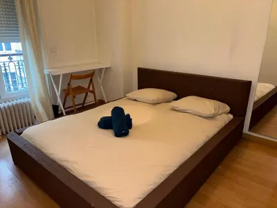 Un ou plusieurs lits dans un hébergement de l'établissement Appartement Tour Eiffel ALESIA PARIS