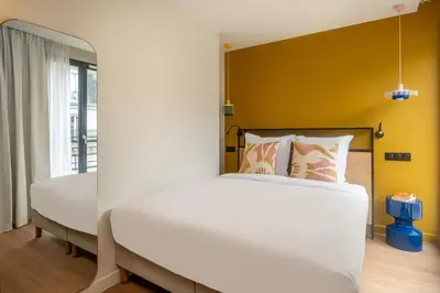Un ou plusieurs lits dans un hébergement de l'établissement Montmartre Paris Suite