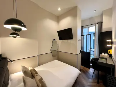 Un ou plusieurs lits dans un hébergement de l'établissement Hôtel des Beaux Arts