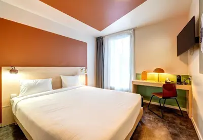 Un ou plusieurs lits dans un hébergement de l'établissement B&B HOME Paris Mairie de Saint-Ouen