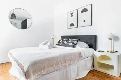 Un ou plusieurs lits dans un hébergement de l'établissement Appartement service Studio au Coeur du 19e - 2P