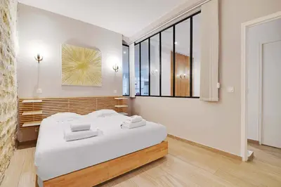 Un ou plusieurs lits dans un hébergement de l'établissement Wonderful apartment - 2BR 8P - Aligre