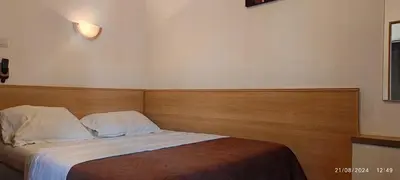 Un ou plusieurs lits dans un hébergement de l'établissement Hôtel Résidence Saint Ouen
