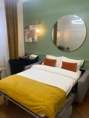 Un ou plusieurs lits dans un hébergement de l'établissement Appartement PARIS avec Parking
