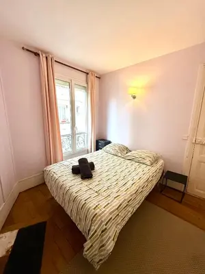Un ou plusieurs lits dans un hébergement de l'établissement Appartement Tour Eiffel Chapu