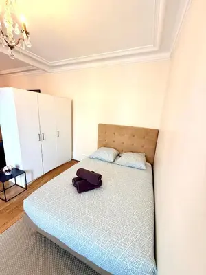 Un ou plusieurs lits dans un hébergement de l'établissement Appartement Tour Eiffel Chapu