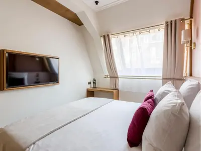 Un ou plusieurs lits dans un hébergement de l'établissement Merveil - Signature Suite - Tour Eiffel - Desaix I