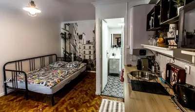 Un ou plusieurs lits dans un hébergement de l'établissement Appartement cozy en plein centre de Paris, près de l'Opéra Garnier