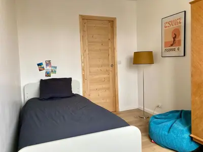 Un ou plusieurs lits dans un hébergement de l'établissement Cosy apartment with a magnificent view 10 min from Paris Exhibition Centre