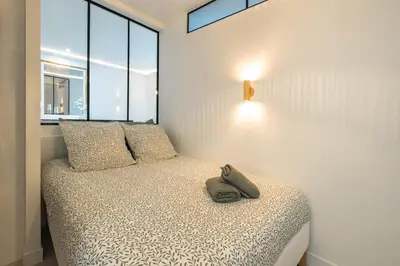 Un ou plusieurs lits dans un hébergement de l'établissement Haussmann Apartment - Champs-Élysées
