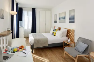 Un ou plusieurs lits dans un hébergement de l'établissement Hotel Résidence Paris Asnières