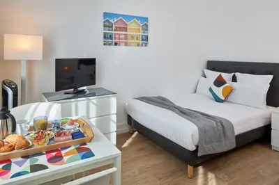 Un ou plusieurs lits dans un hébergement de l'établissement Hotel Résidence Paris Asnières