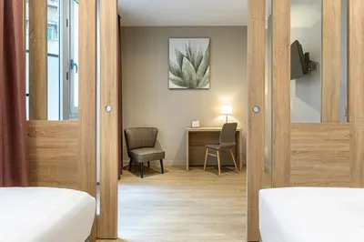 Un ou plusieurs lits dans un hébergement de l'établissement Paris d'Issy Hôtel Porte de Versailles