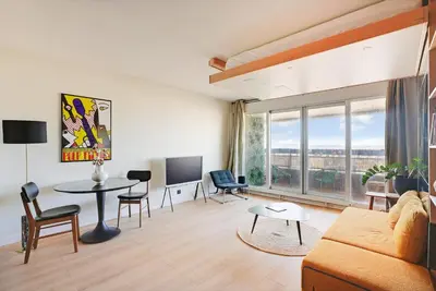 Coin salon dans l'établissement Studio refait à neuf avec balcon et vue sur la Seine - bail mobilité