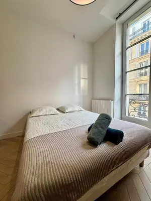 Un ou plusieurs lits dans un hébergement de l'établissement Appartement Marais Sentier